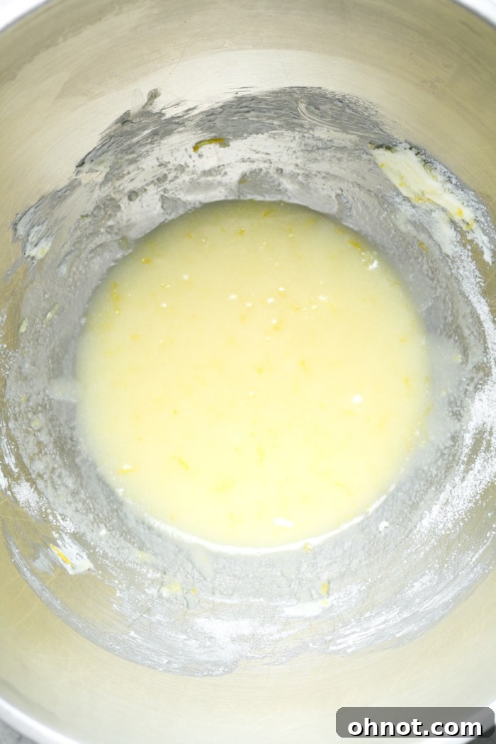 Yellow batter of lemon brownies in a mixing bowl, showing its creamy texture.