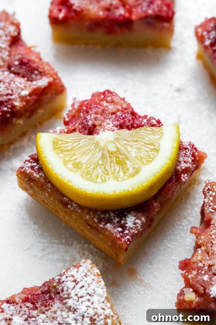 A single lemon raspberry bar, ready to be eaten.