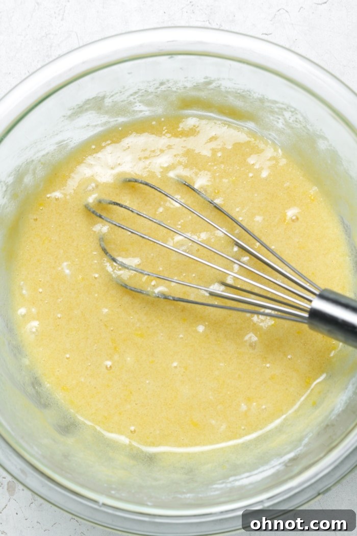 Whisked eggs and lemon juice being added to filling ingredients.