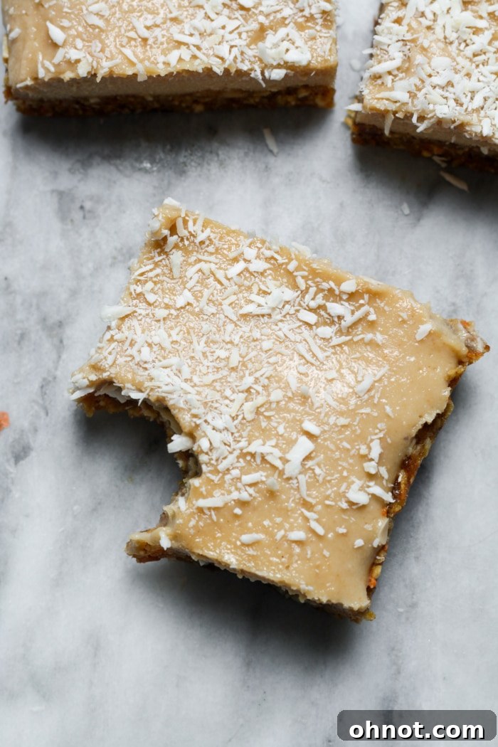 A close-up of a vegan cheesecake bar, showing its creamy texture and crust.