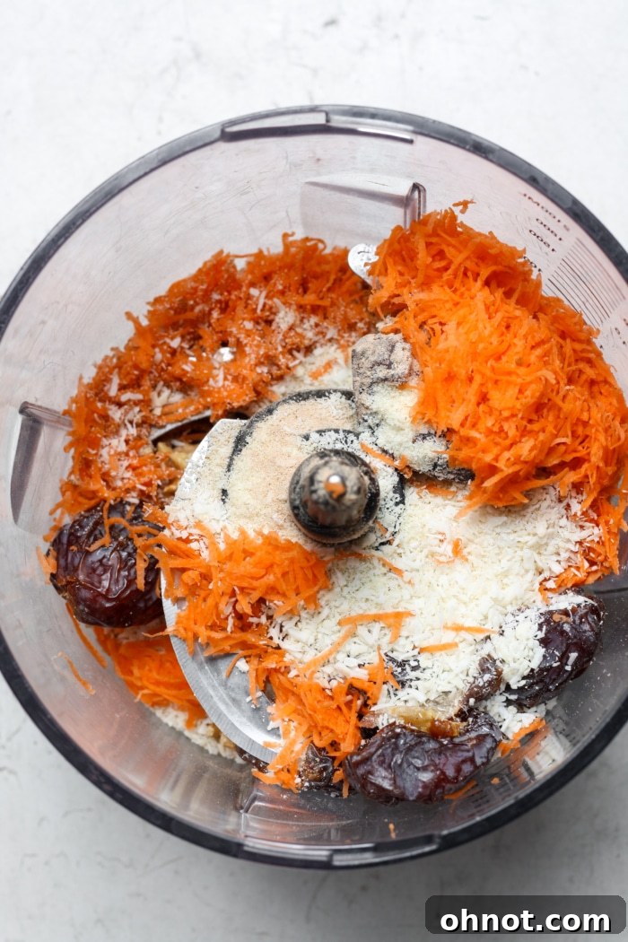 Shredded carrots and coconut in food processor, part of the crust mixture.