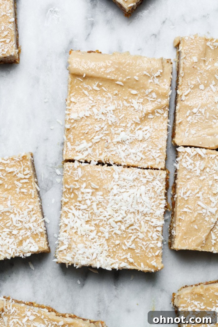 Beautifully prepared vegan cheesecake bars topped with shredded coconut.