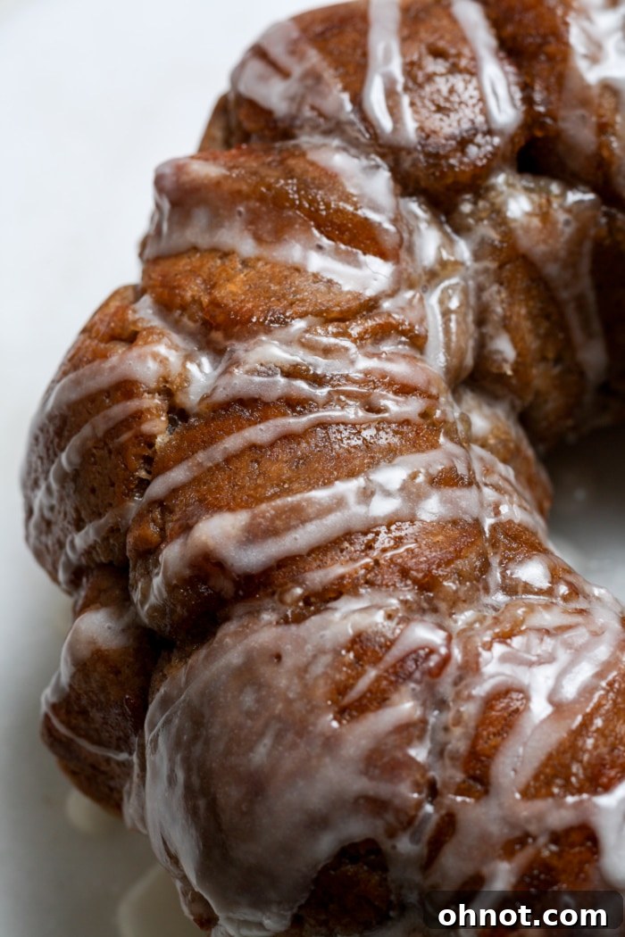 Glazed gluten-free monkey bread on a serving plate.