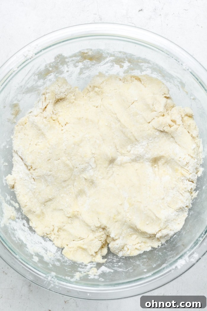Thick, sticky scone dough in a mixing bowl.