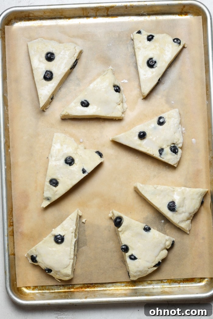 Scone dough cut into 8 triangular pieces.