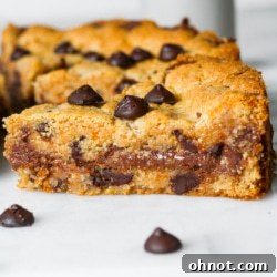 A slice of chocolate chip cookie pie with a fork.