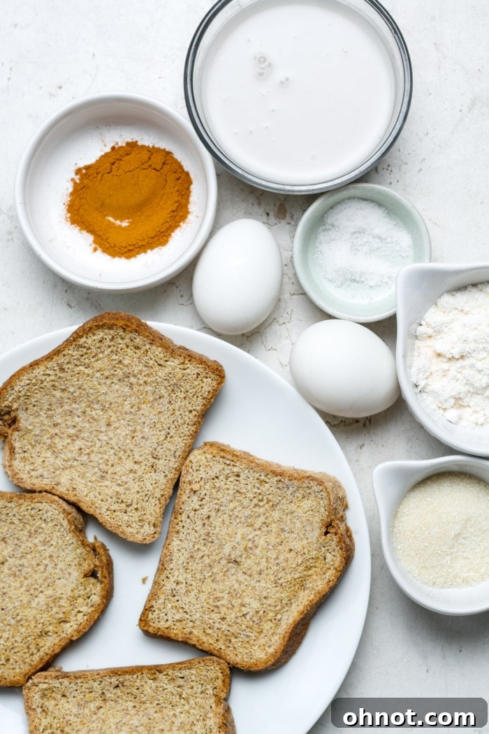 A selection of raw ingredients artfully arranged for making gluten-free French toast, including eggs, milk, bread slices, cinnamon, and nutmeg.