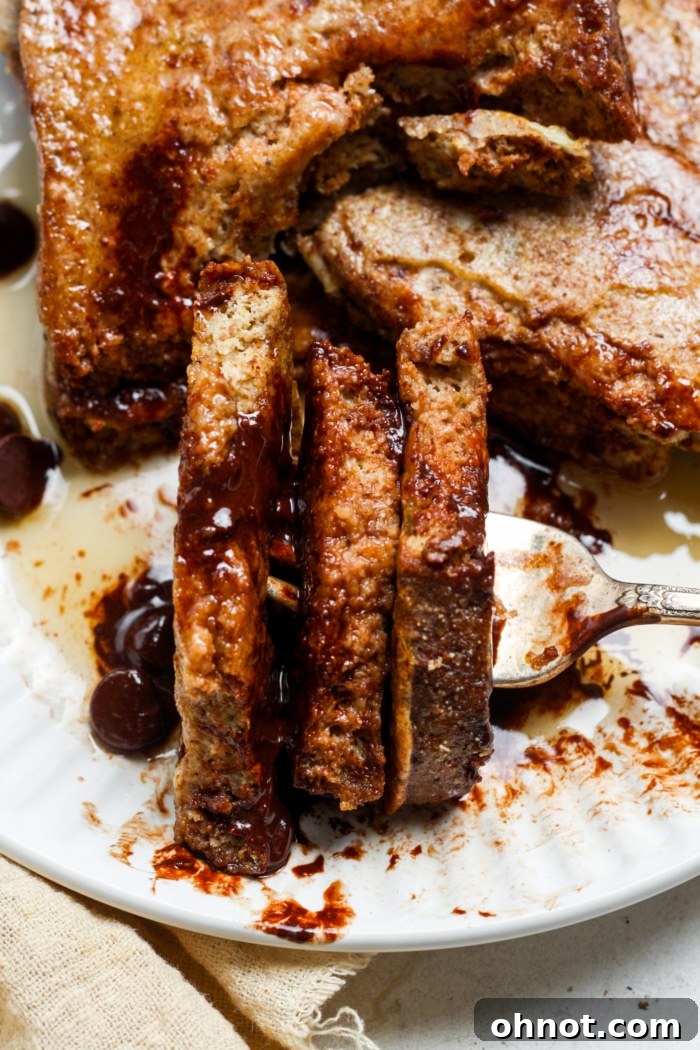 Beautifully cut slices of gluten-free French toast, showcasing a fluffy, tender interior.