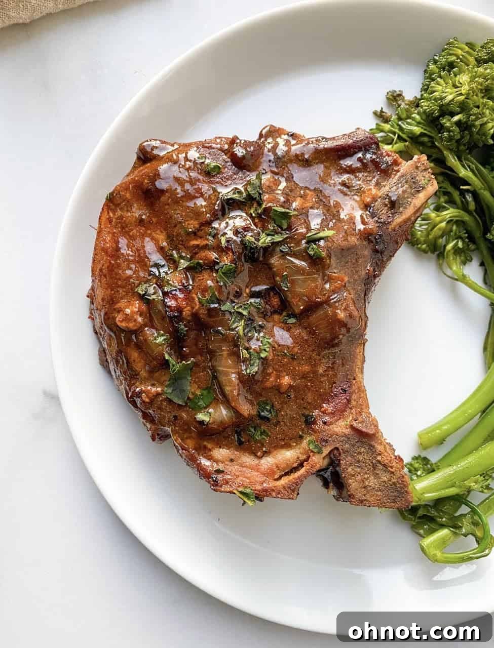 Perfectly seared Whole30 Balsamic Pork Chops with a rich, glossy balsamic reduction sauce.