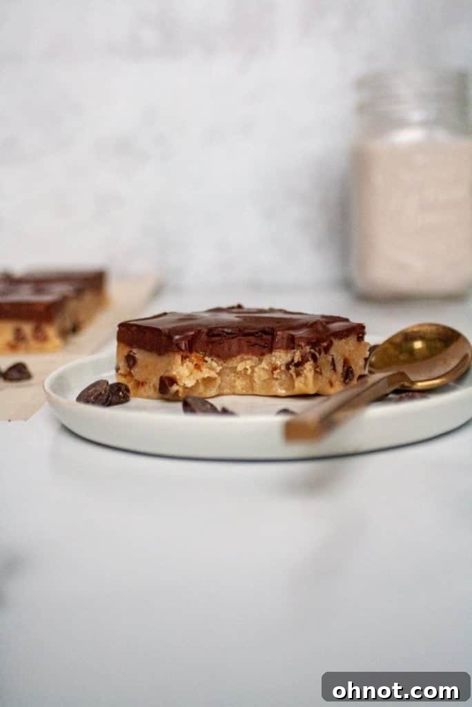 Close-up of paleo vegan cookie dough bars with a rich chocolate layer, showing their perfectly set texture.