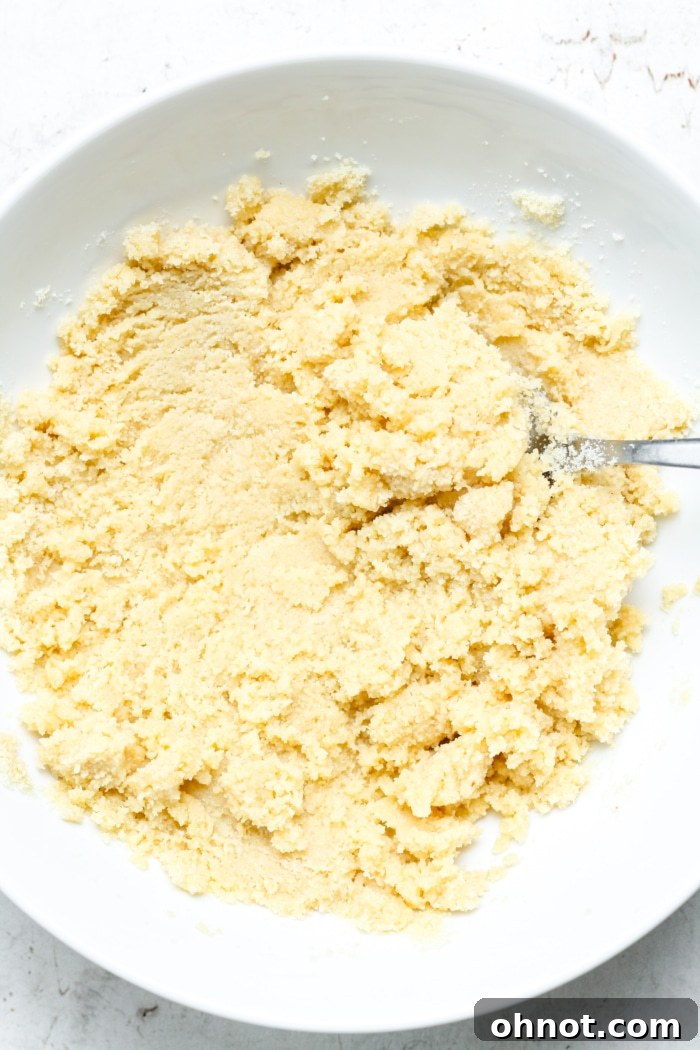 A mixing bowl with a thick almond flour mixture for the shortbread base.