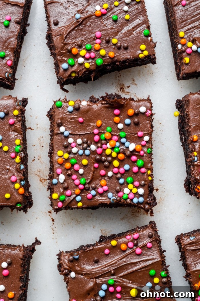 Close-up of a perfectly sliced Cosmic Brownie with rainbow sprinkles.
