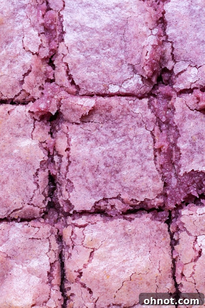 Stacked slices of ube brownies with their beautiful purple color and fudgy texture visible.