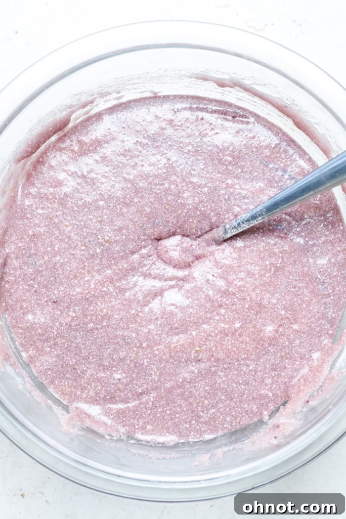 Smooth and thick ube brownie batter in a mixing bowl, ready for baking.