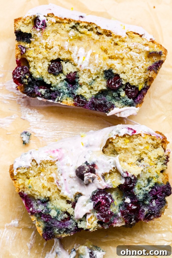Slices of lemon blueberry loaf, beautifully frosted.