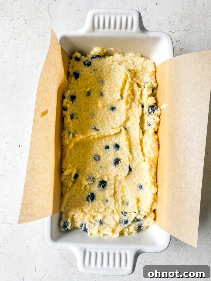 Loaf pan filled with lemon blueberry batter.