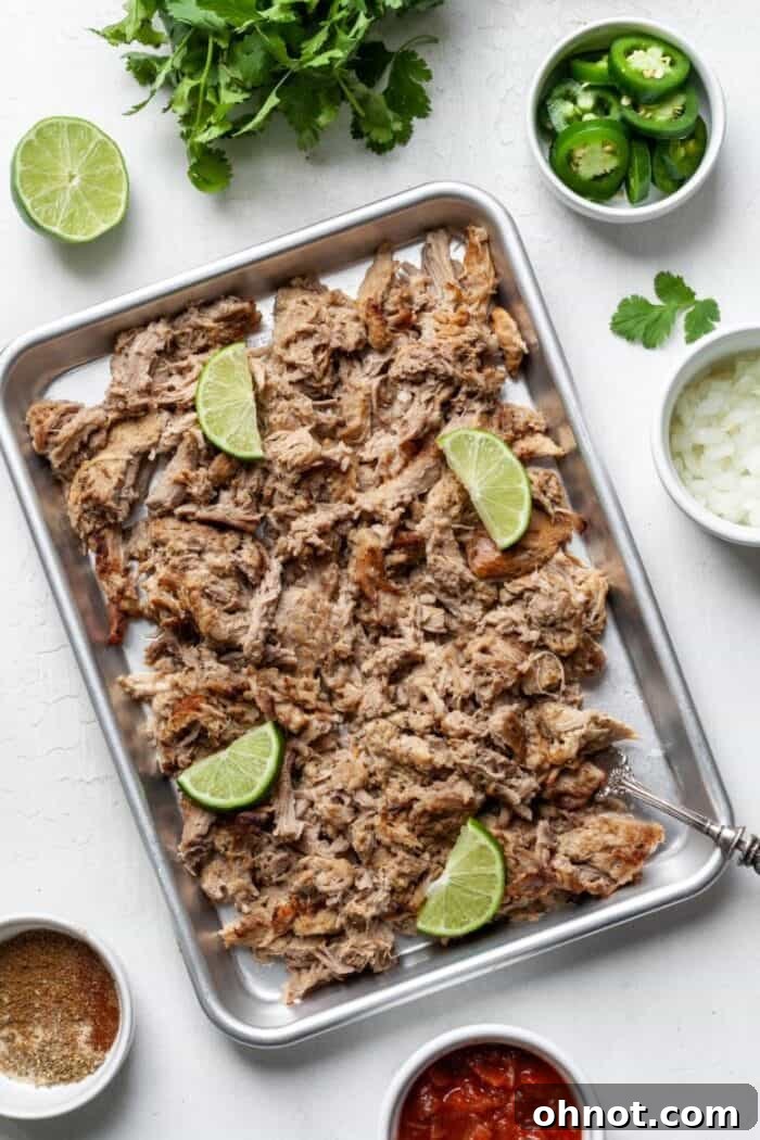 Keto Pork Carnitas spread out on a pan, showcasing their crispy texture.