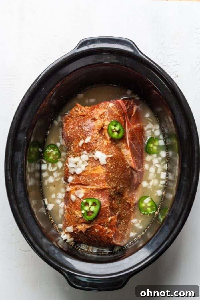 Crock pot with Mexican pulled pork simmering.