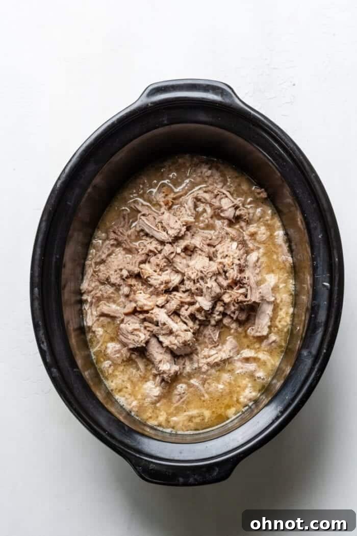 Pulled Mexican pork in a slow cooker, ready for the next step.