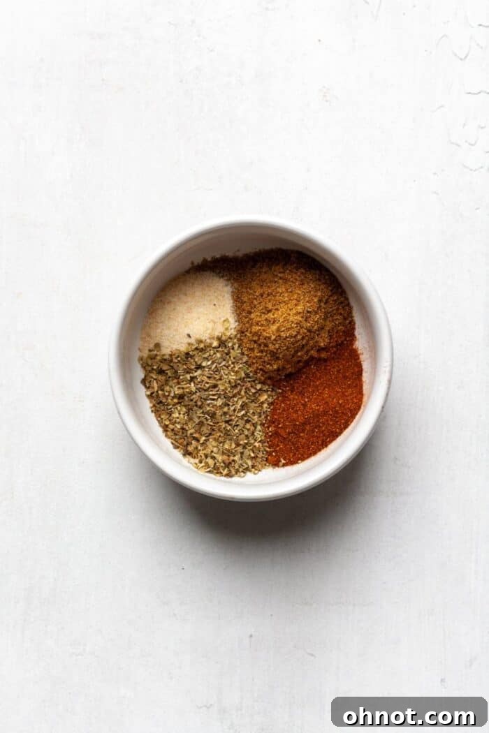 Spices in a white bowl, ready for the pork rub.