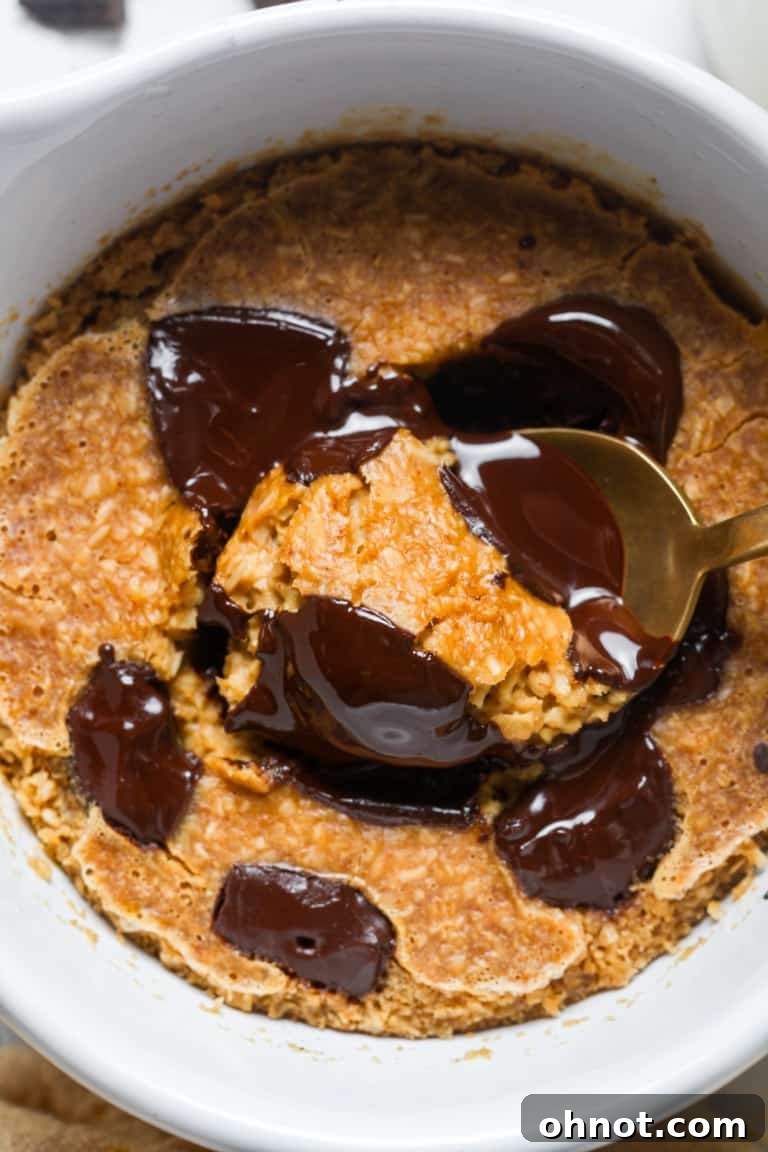 A bowl of baked oats without banana, topped with berries and syrup.