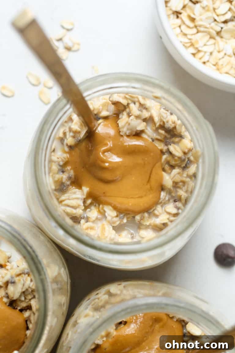 A jar of overnight oats with protein powder, mixed with fruit.