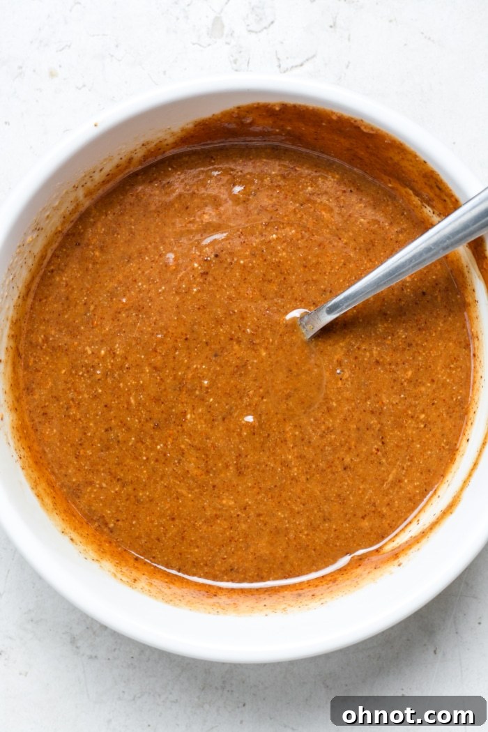 Close-up of a bowl with creamy peanut butter caramel sauce.