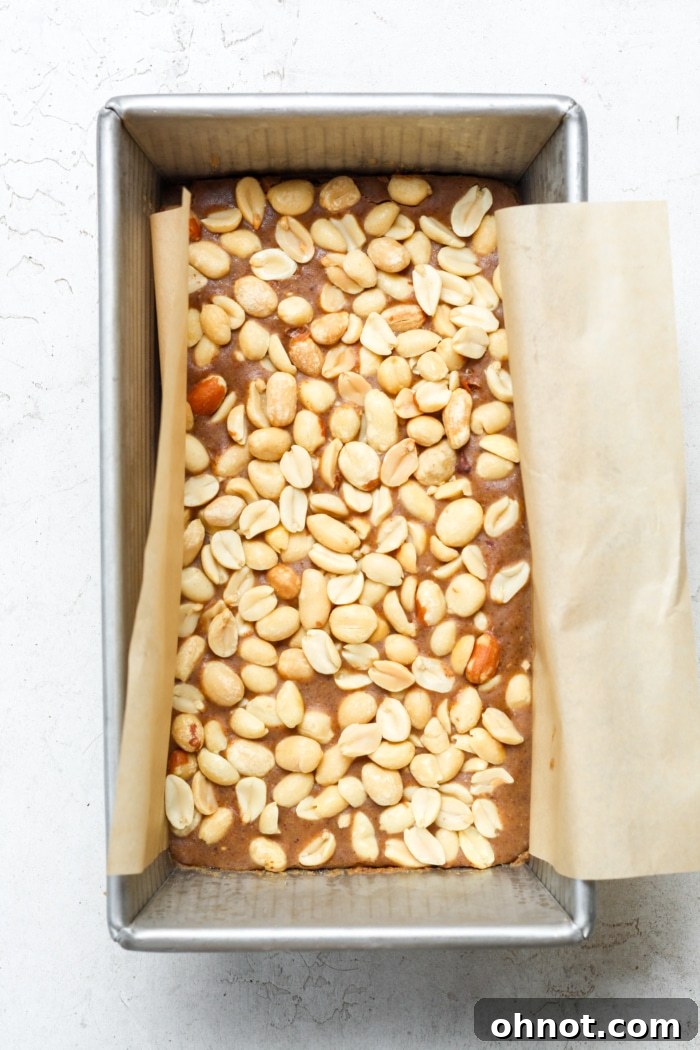 Frozen homemade payday bars in a pan, ready for slicing.
