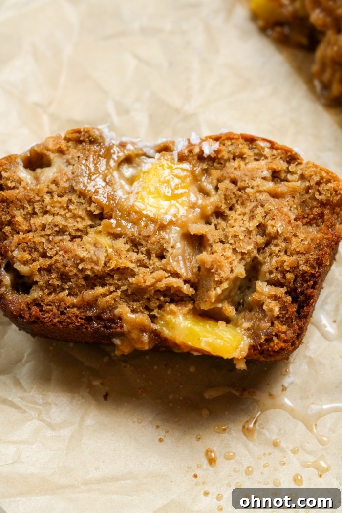 Sliced coconut pineapple bread on a white plate, showing its moist interior.
