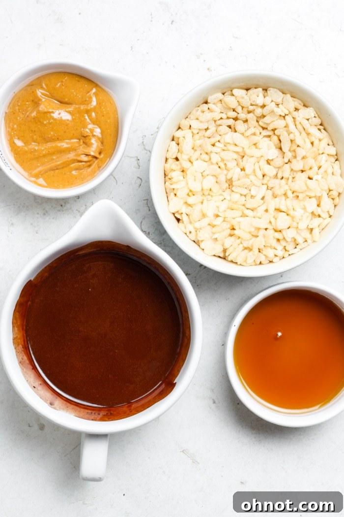 Ingredients for healthy peanut butter cups laid out on a surface.