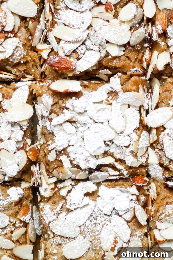 Almond croissant blondies, garnished with powdered sugar.