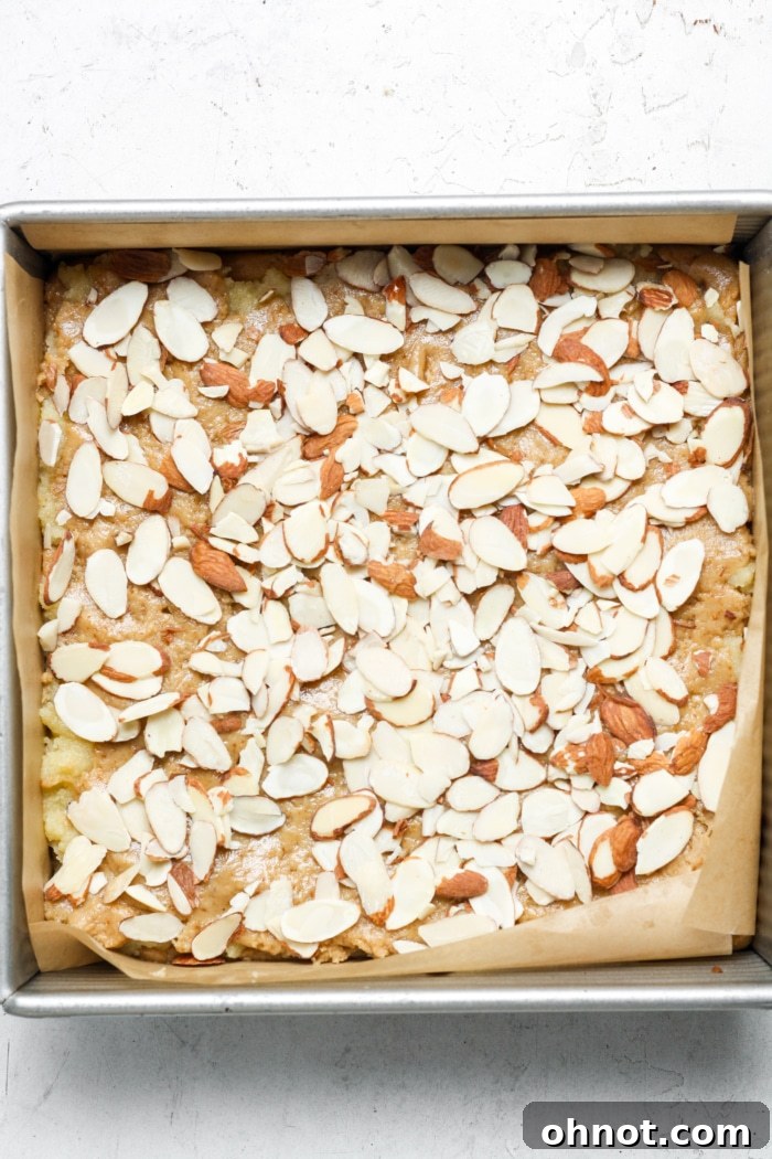 Baked almond croissant blondies with slivered almonds on top.