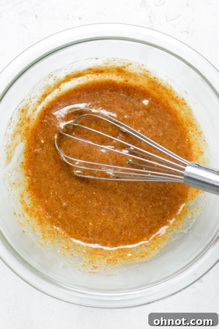 Blondie batter with wet ingredients in a mixing bowl.