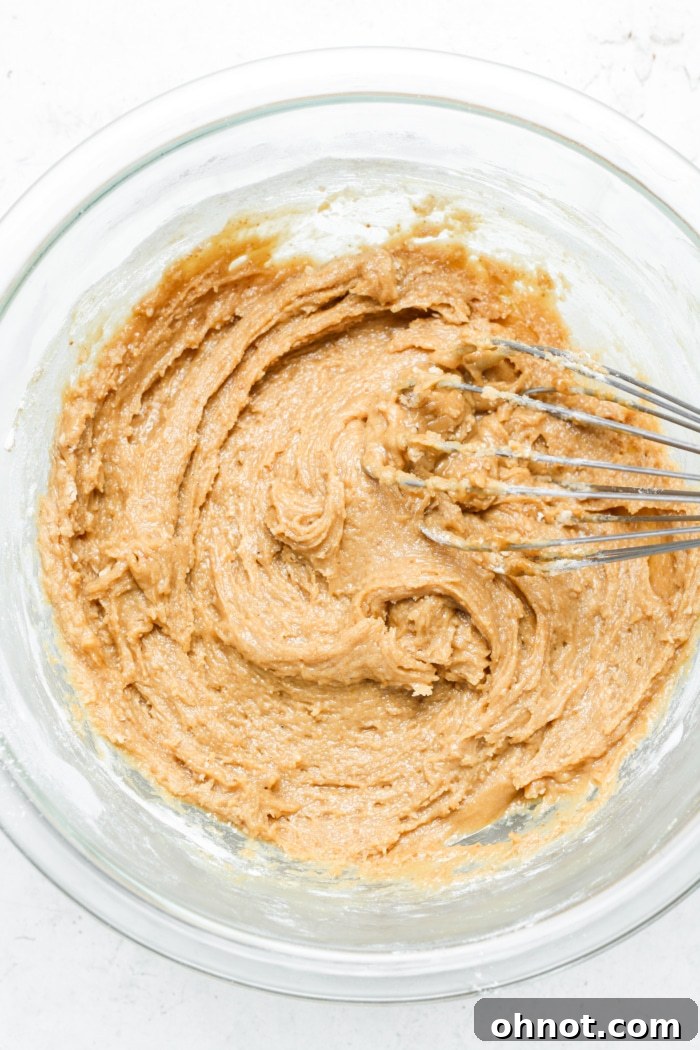 Thick blondie batter in a mixing bowl.