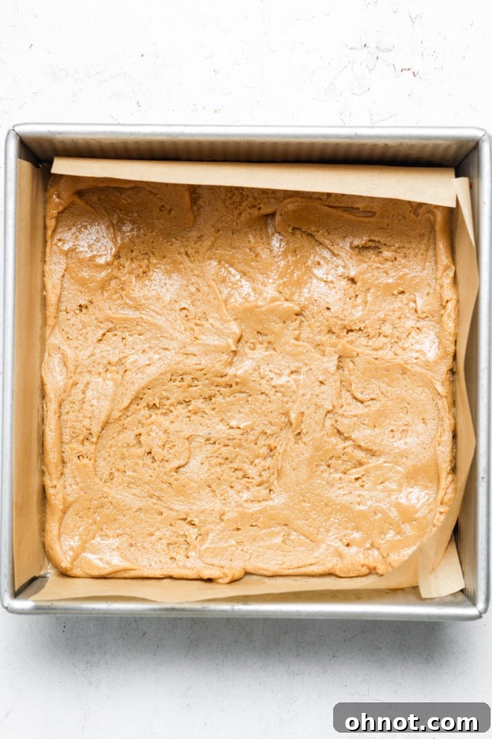 Blondie batter spread in a baking pan.