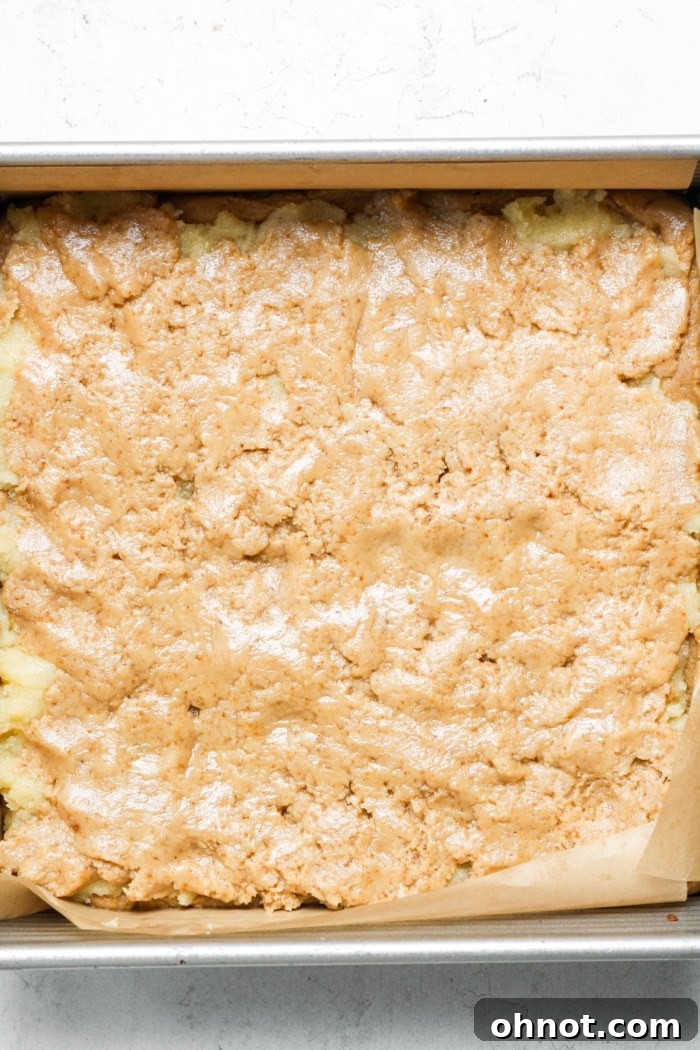 Layers of dough in a square baking pan before baking.