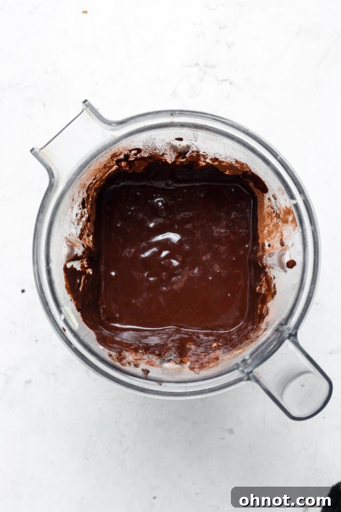Smooth, rich chocolate brownie batter in a blender after mixing.