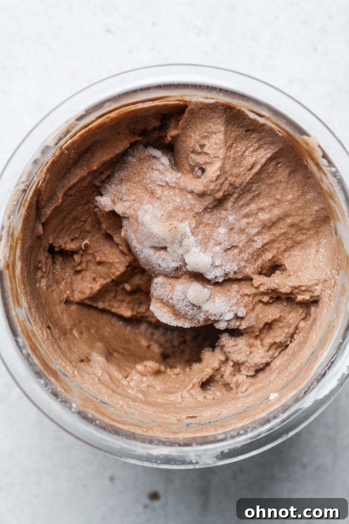 Frozen chocolate mixture in a Ninja Creami pint jar, ready for spinning.
