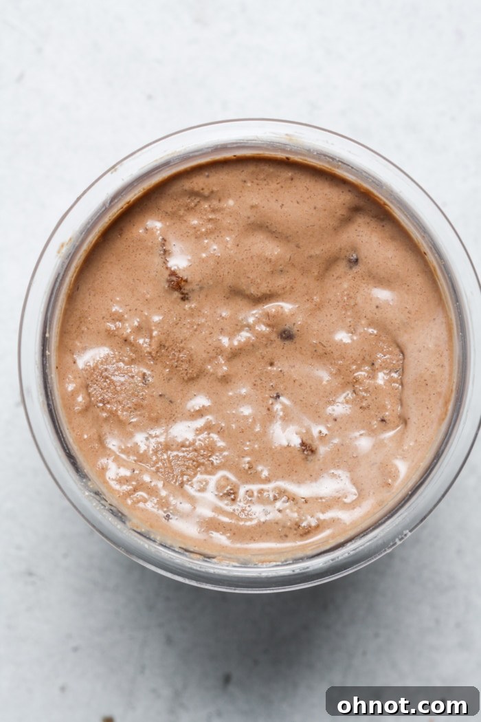 Perfectly smooth and creamy chocolate ice cream in a Ninja Creami pint after being spun.