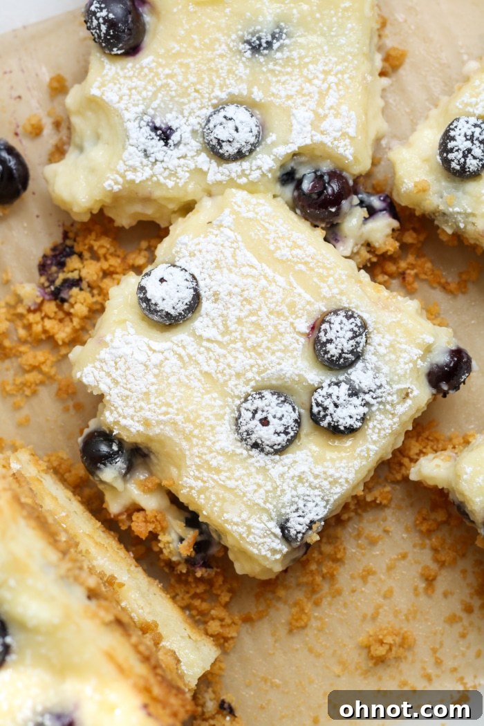 Perfectly sliced cheesecake squares on a white surface.