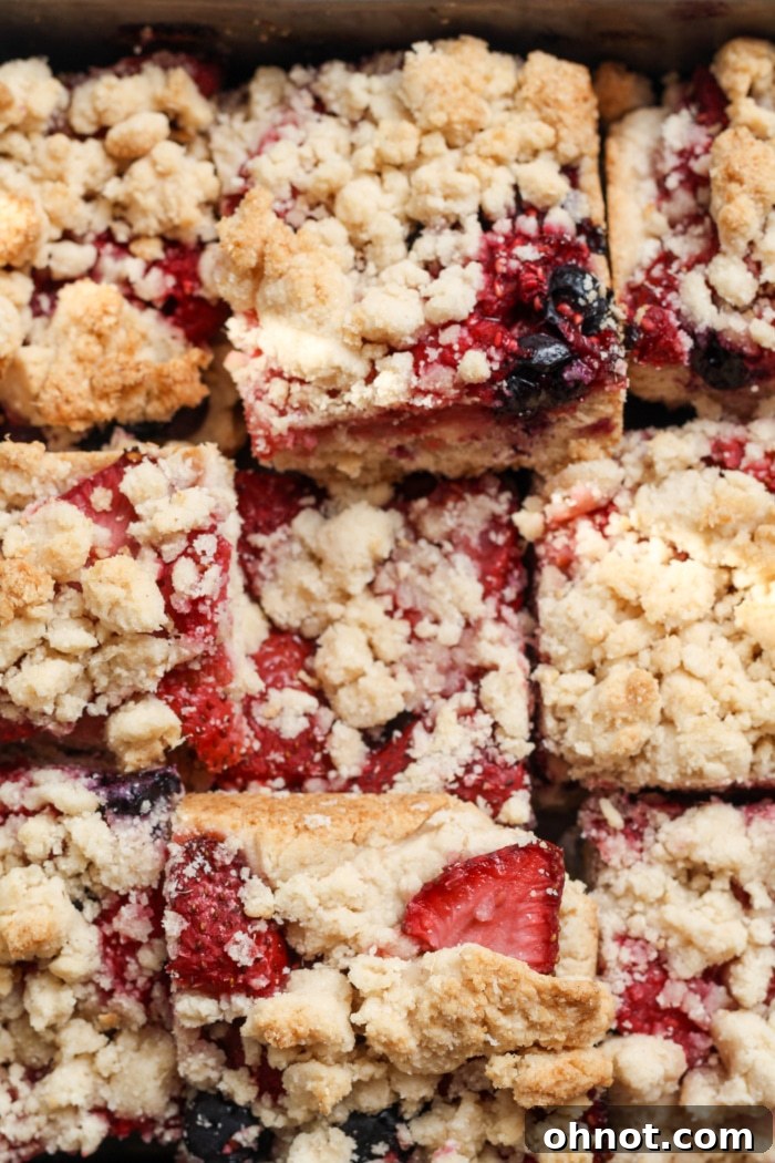 Freshly baked strawberry crumble bars, showcasing their golden crust and juicy filling.