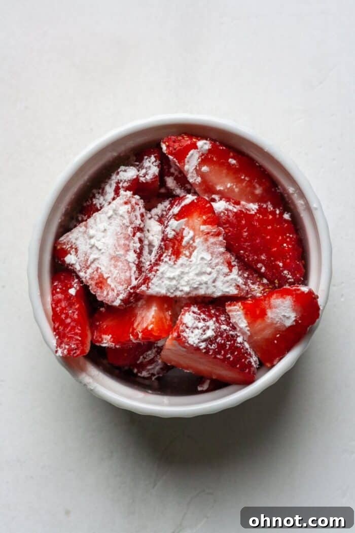 Diced strawberries lightly coated in tapioca flour in a bowl.