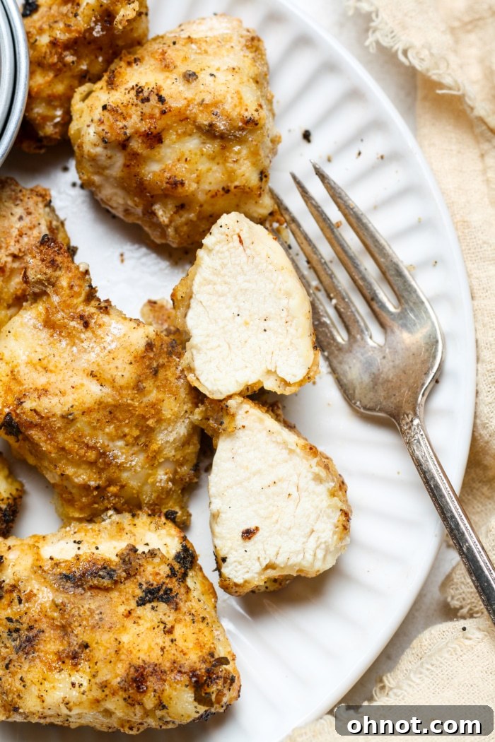 Perfectly cooked white meat chicken pieces on a plate, ready to be served.