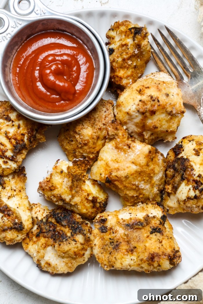 A generous serving of crispy gluten-free popcorn chicken on a plate, garnished and ready to be enjoyed.
