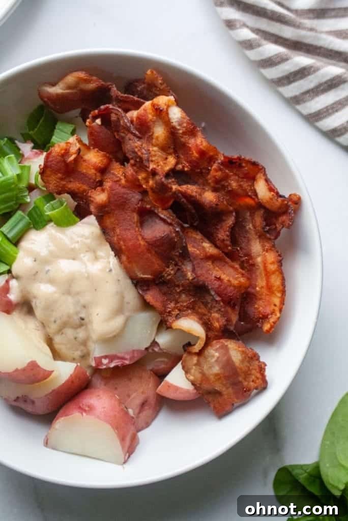A white bowl showcasing the fresh, wholesome ingredients laid out for making the potato salad, including red potatoes, fresh herbs, and a bottle of ranch dressing.