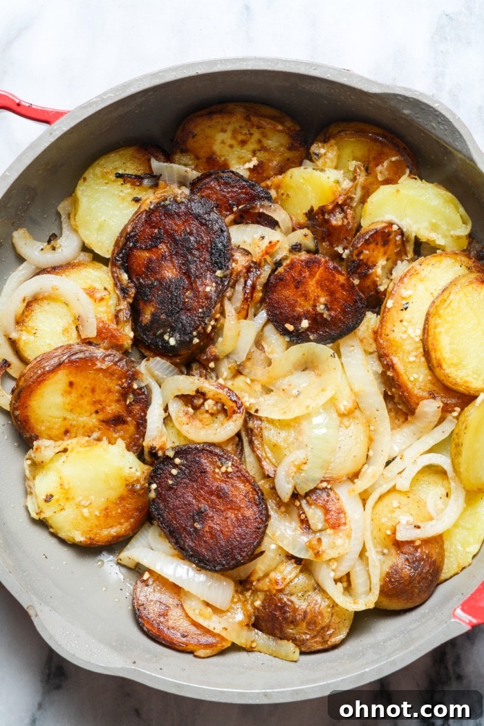 Crispy potatoes and caramelized onions in skillet
