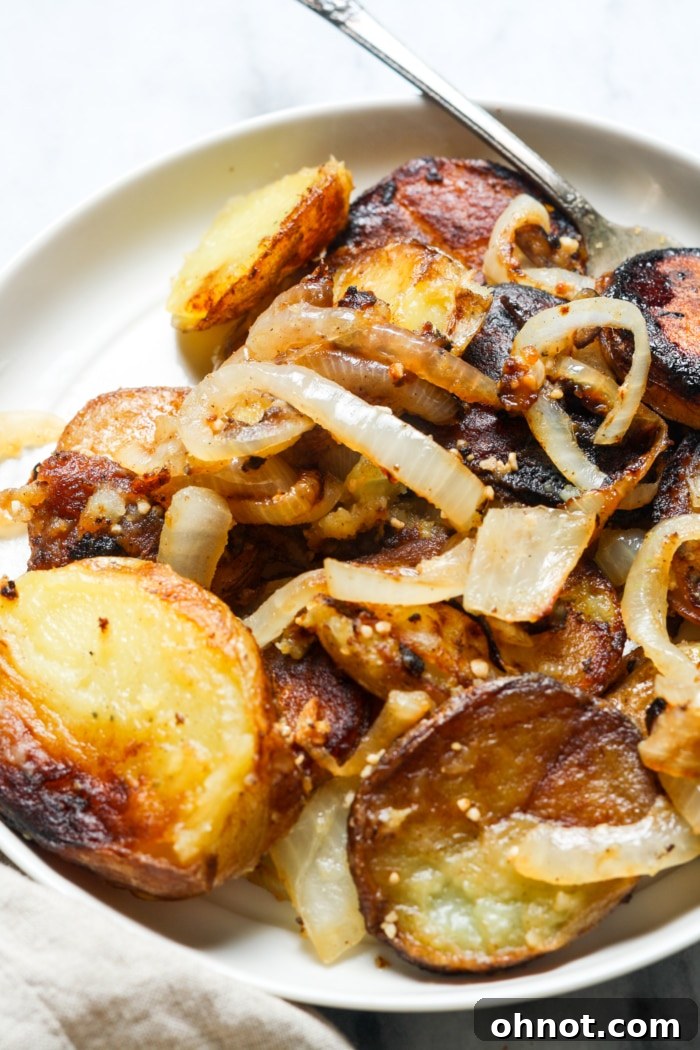 Close up of potatoes with onions in a skillet