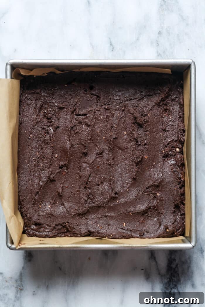 Brownie batter in square pan.