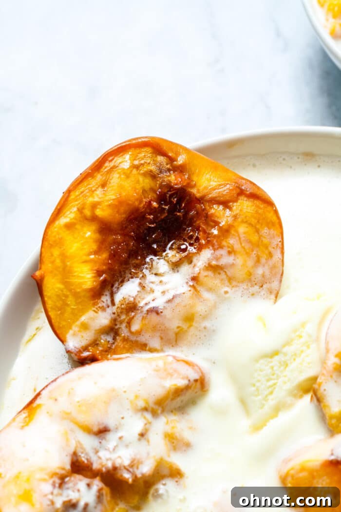 Delicious baked peaches served with a scoop of vanilla ice cream, ready to be enjoyed.