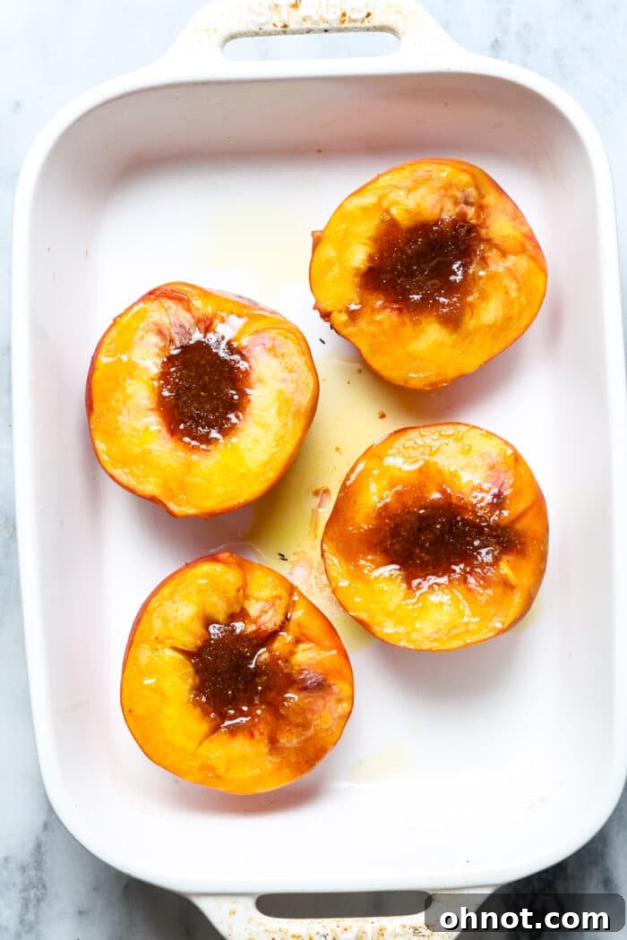 Cinnamon roasted peaches with a golden, bubbly topping in a baking dish.